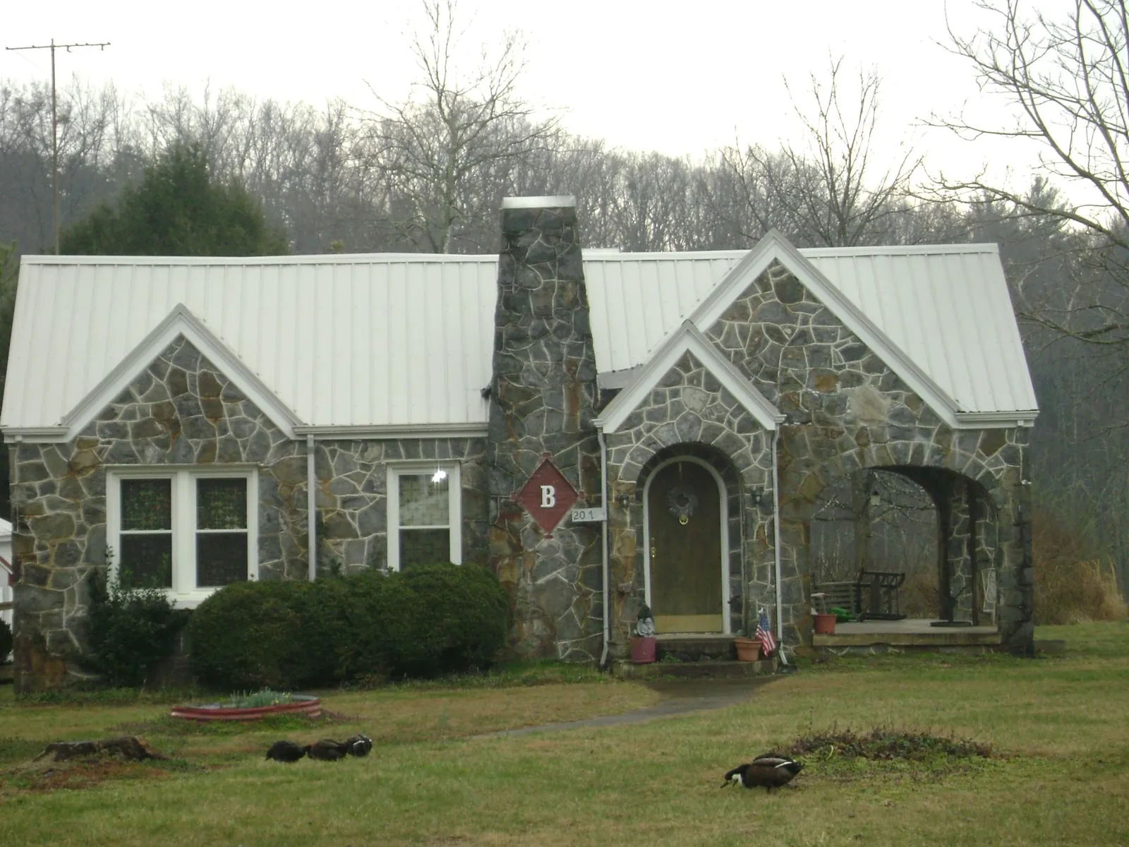 White metal roof on a stone cottage with steep gables in Cumberland