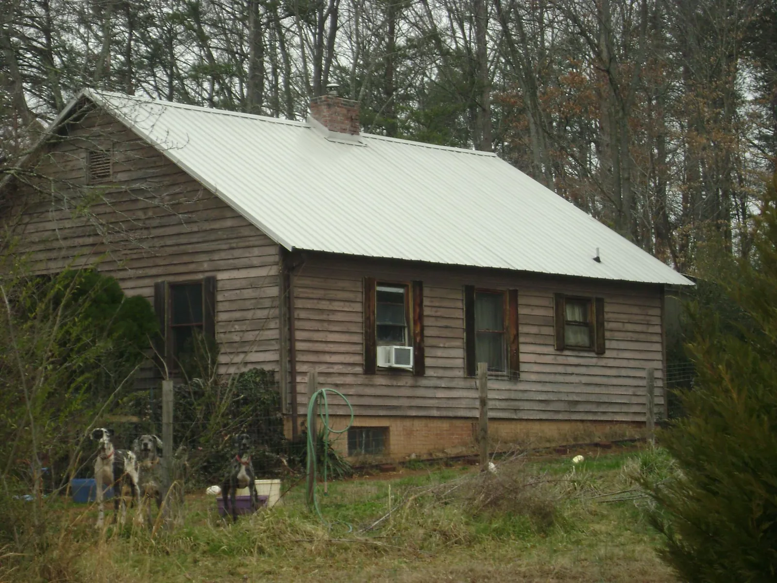 White metal roof on an old wood sided farmhouse, from a Asphalt Shingle Roof Repair job in Cumberland